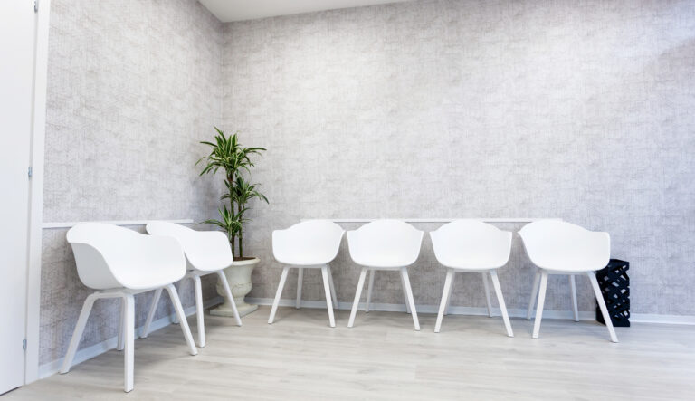 Space Care commercial business workspace office cleaning Waiting room interior with six white chairs on the parquet floor. White and modern room in office hotel lobby